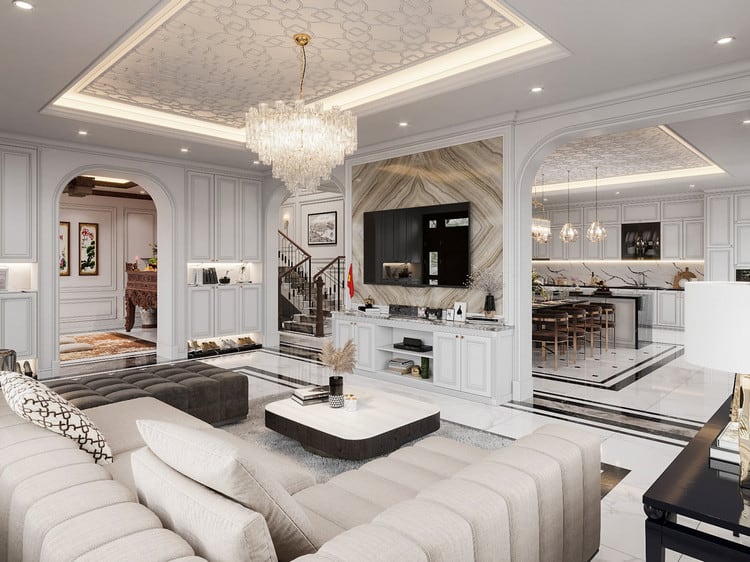 Phòng khách luxury với tường ốp đá cẩm thạch, kệ sách gỗ và đèn chùm hiện đại.