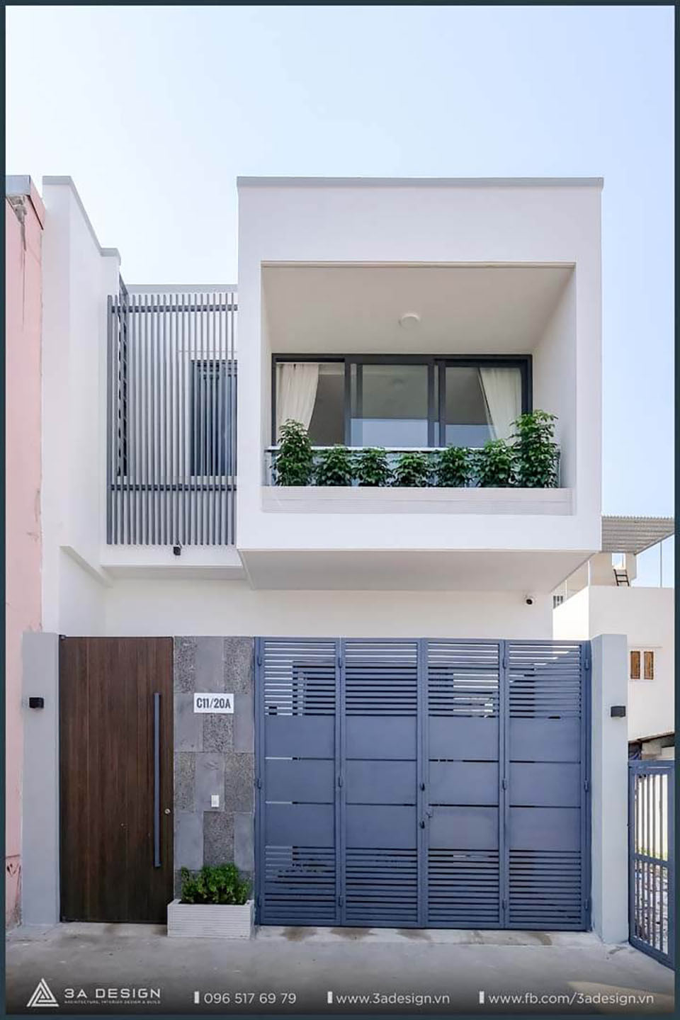 Nhà phố hiện đại hai tầng mặt tiền trắng với ban công cây xanh, thiết kế và thi công bởi 3A Design tại Bình Chánh.
