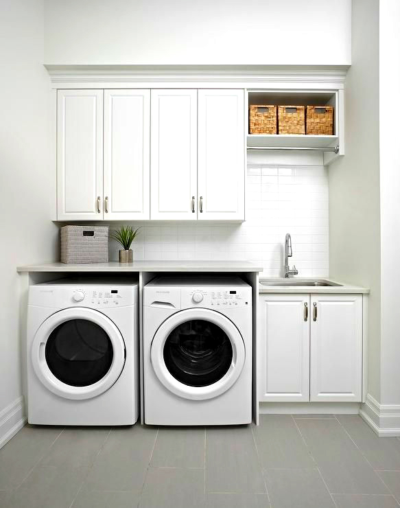 khu vực giặt sấy được bố trí gọn gàng với hai máy giặt và tủ lưu trữ màu trắng.