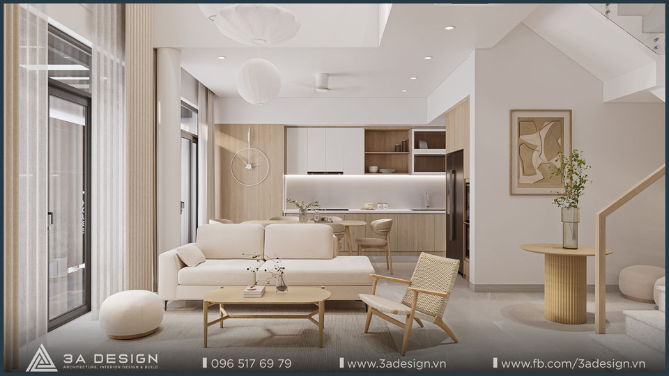 Phòng khách nhà phố với sofa chữ I màu kem, bàn trà gỗ, ghế mây, cửa kính lớn đón sáng, nội thất Japandi tối giản do 3A Design thiết kế.