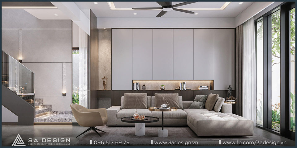 Phòng khách biệt thự hiện đại với sofa lớn, ánh sáng tự nhiên và thiết kế tối giản thanh lịch.
