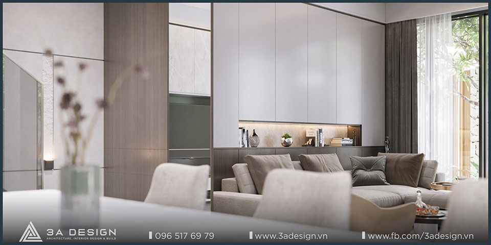 Phòng khách hiện đại với sofa trung tính, tủ âm tường gọn gàng và ánh sáng tự nhiên tràn ngập.