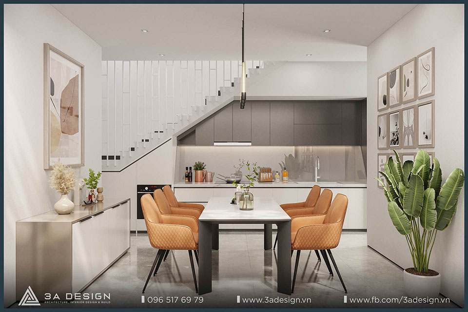 Bếp gầm cầu thang màu trắng và xám đậm. Tích hợp bồn rửa, bếp từ và lò nướng dưới dạng module, tối ưu công năng cốt lõi.