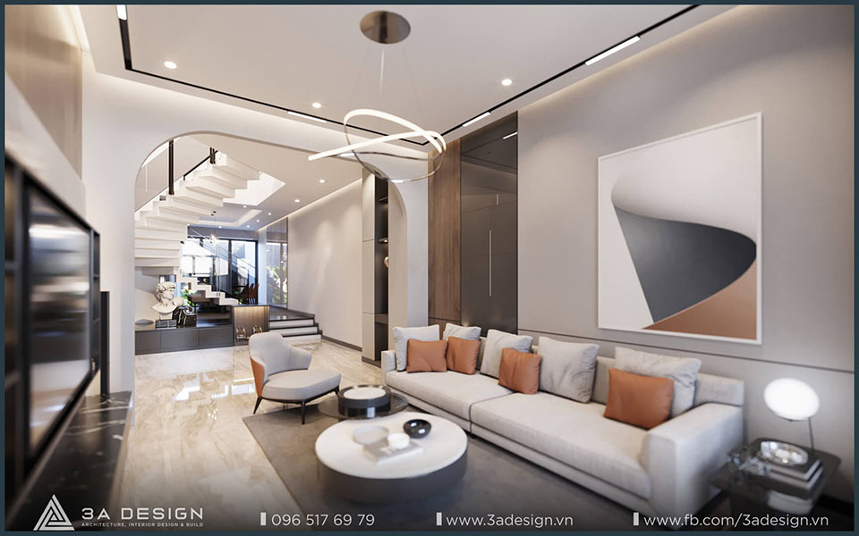 Phối cảnh Tầng 1 nhà phố thiết kế không gian mở liên thông, với phòng khách hiện đại, sofa màu be, đèn trần nghệ thuật và cầu thang trắng nằm sau vòm cong, sàn đá cẩm thạch sáng bóng.