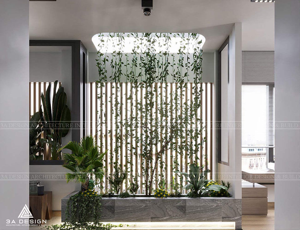 Không gian nội thất theo phong cách Biophilic Design với tiểu cảnh cây xanh, bệ đá và vách ngăn gỗ.