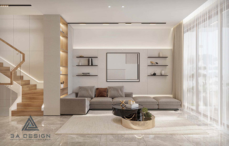 Phòng khách hiện đại với sofa góc màu trung tính, kệ tường âm, tranh treo tường tối giản và ánh sáng tự nhiên